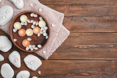 Photo of Flat lay composition with spa stones and space for text on wooden background