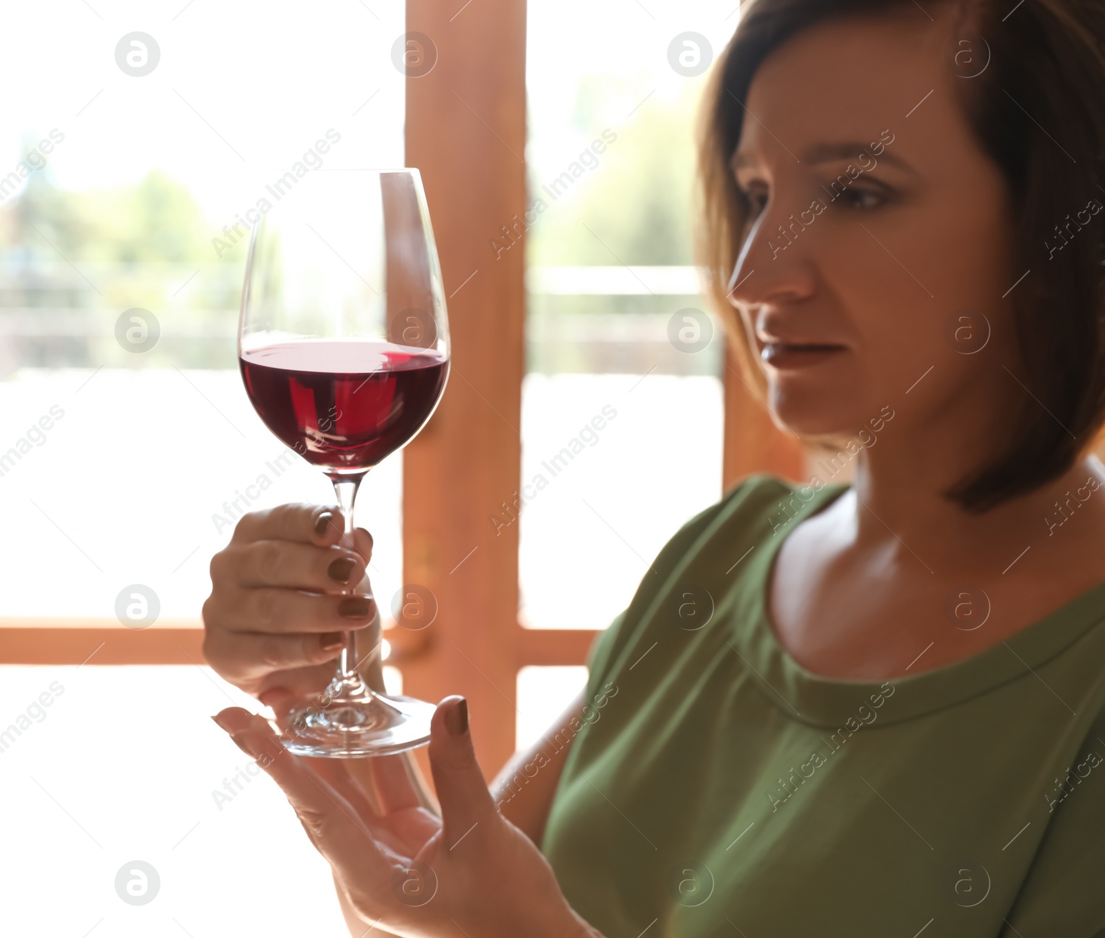 Photo of Woman with glass of red wine indoors