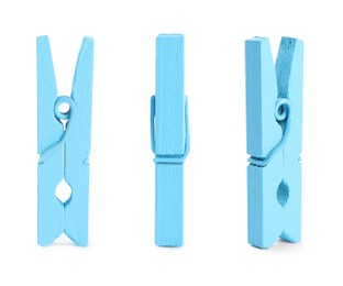 Image of Set with blue wooden clothespins on white background