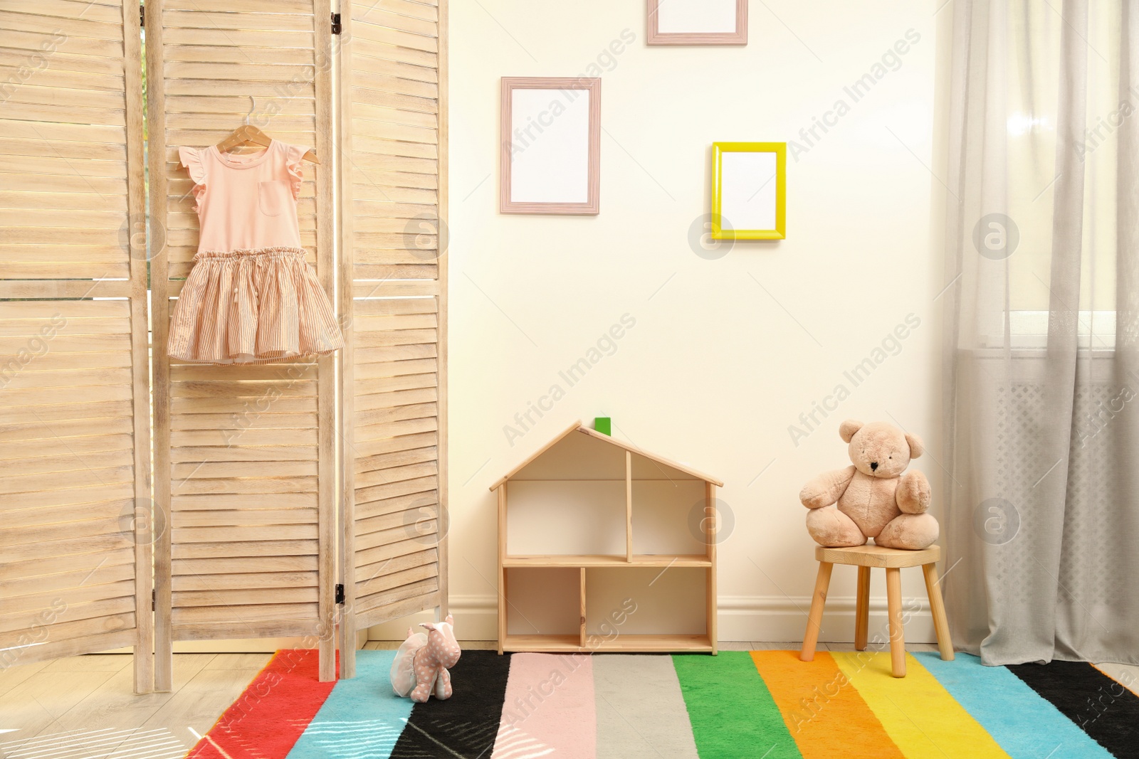 Photo of Modern folding screen in stylish baby room interior