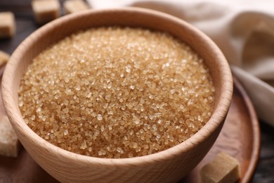 Brown sugar in bowl on table, closeup