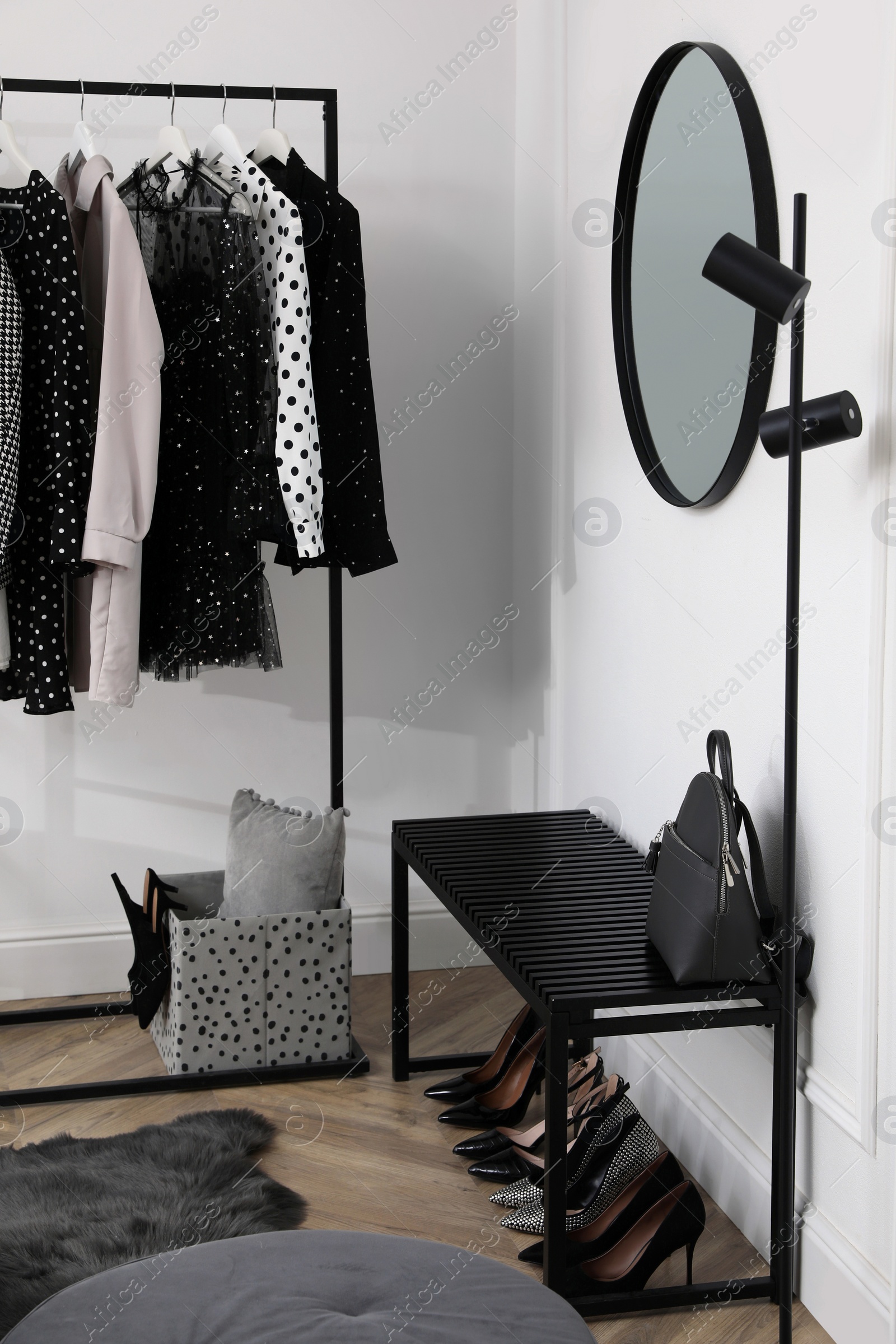 Photo of Dressing room with stylish clothes, shoes and accessories. Elegant interior design