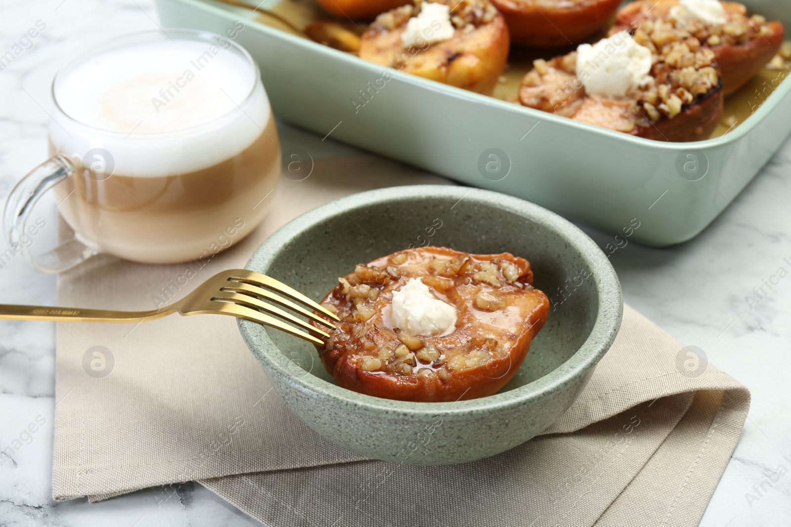 Photo of Tasty baked quinces with nuts and cream cheese served on table