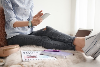 Female blogger with smartphone indoors