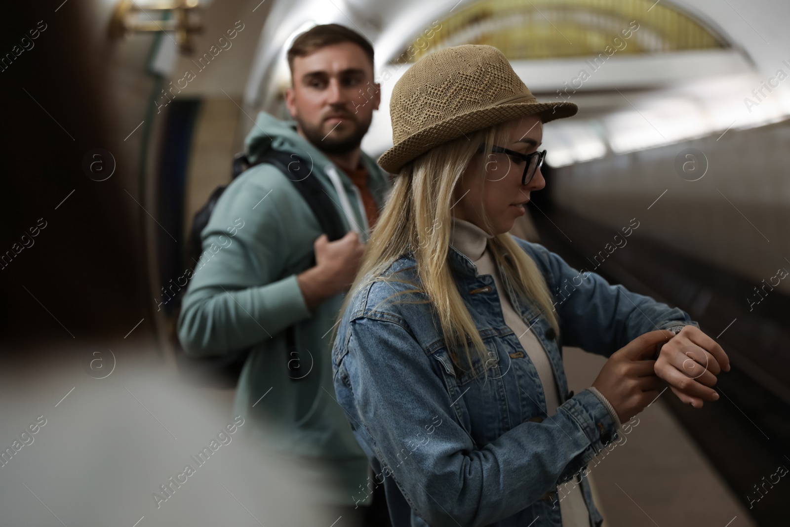 Photo of Young woman waiting for train at subway station. Public transport