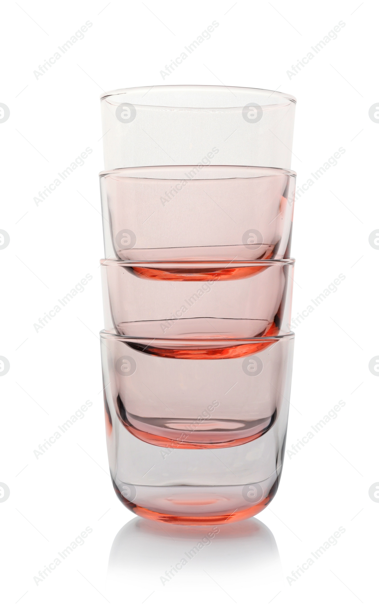 Photo of Stack of empty colorful whiskey glasses on white background