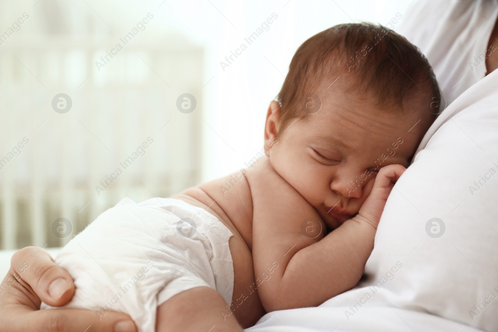 Photo of Young mother with her little baby at home