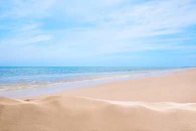 Image of Beautiful beach with golden sand near sea 