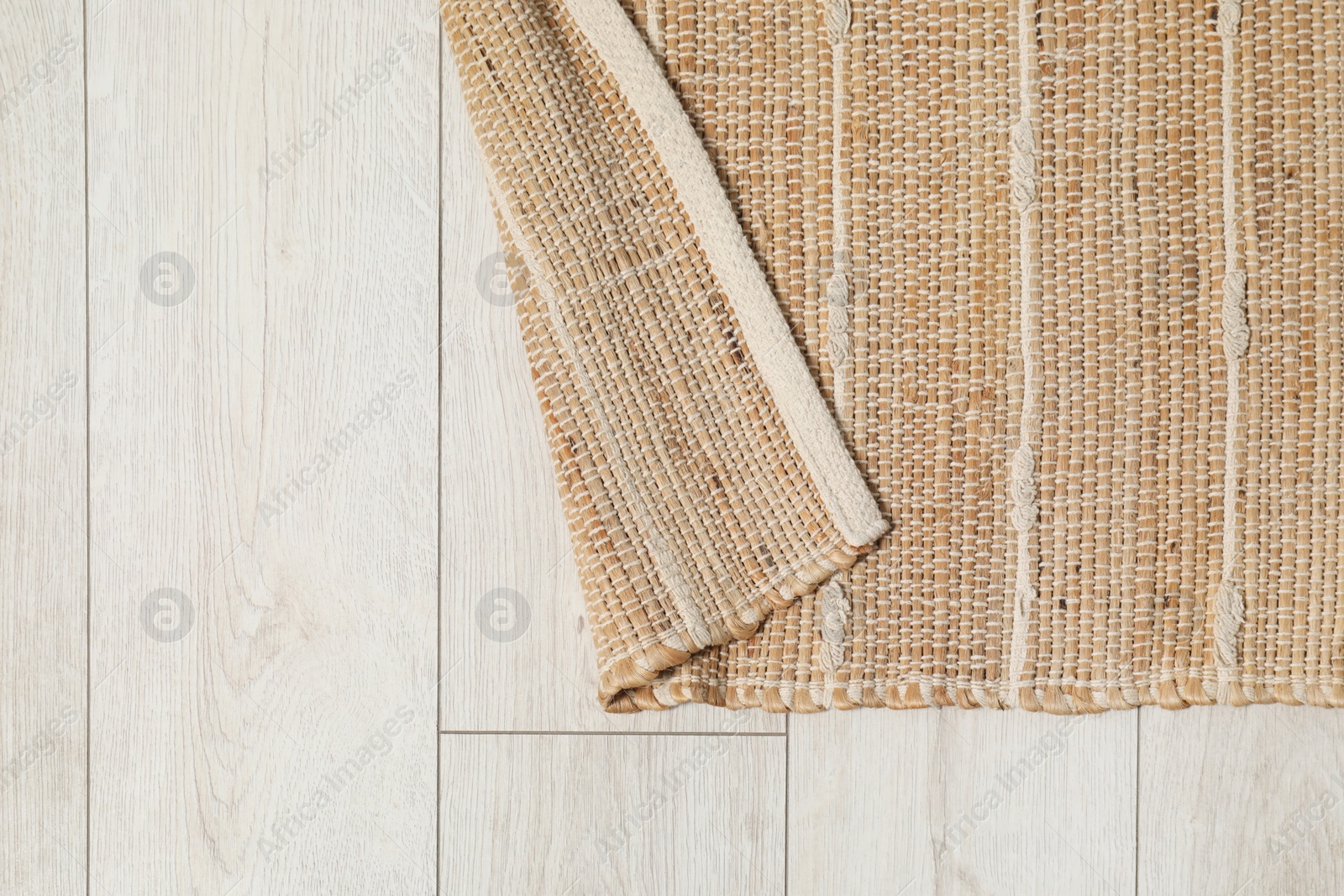 Photo of Soft carpet with pattern on white laminated floor indoors, top view. Space for text