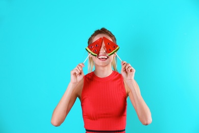 Photo of Young pretty woman with candies on colorful background