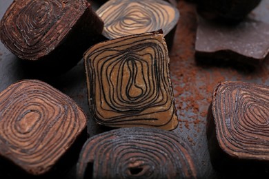 Photo of Different tasty chocolate candies on table, closeup