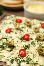 Photo of Fresh natural butter board with cut olives, dill and pepper on table, closeup