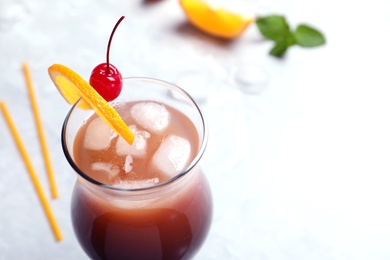 Photo of Glass of tasty refreshing cocktail on table, closeup. Space for text