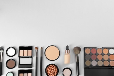 Photo of Flat lay composition with makeup brushes on light background, space for text