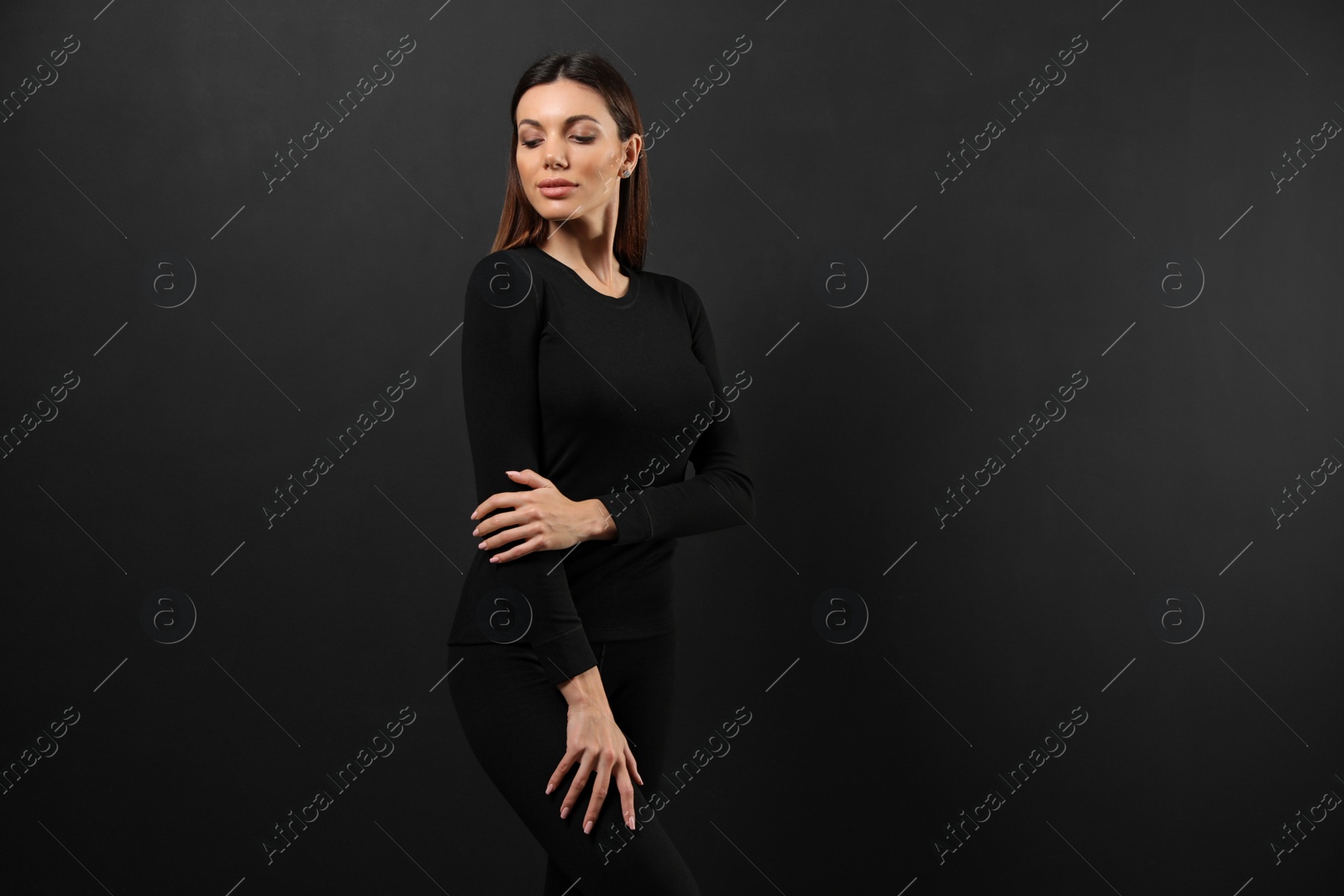 Photo of Woman wearing thermal underwear on black background