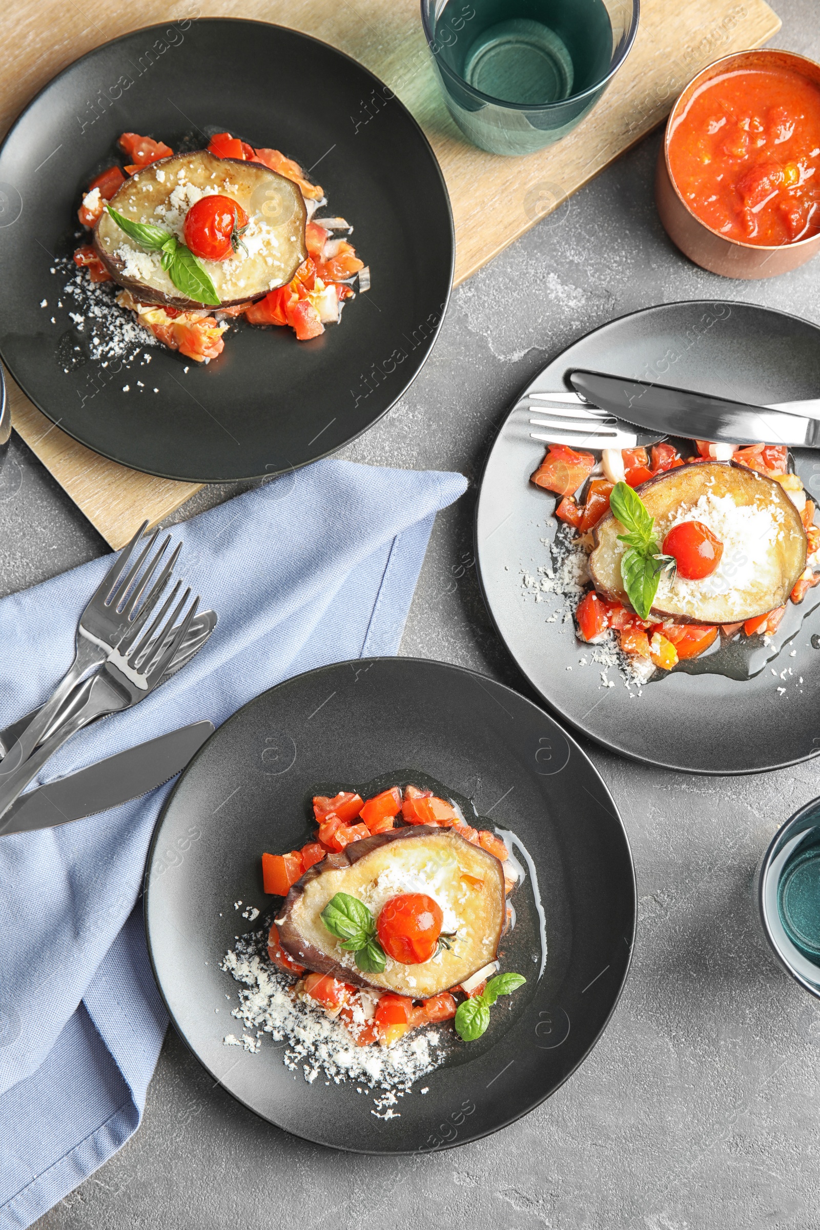 Photo of Flat lay composition with baked eggplant, tomatoes and cheese served on table