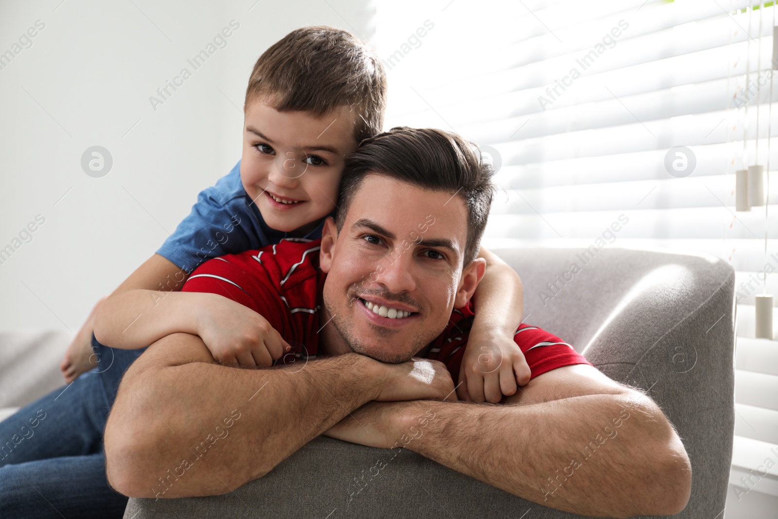 Photo of Dad and son spending time together at home. Happy Father's Day