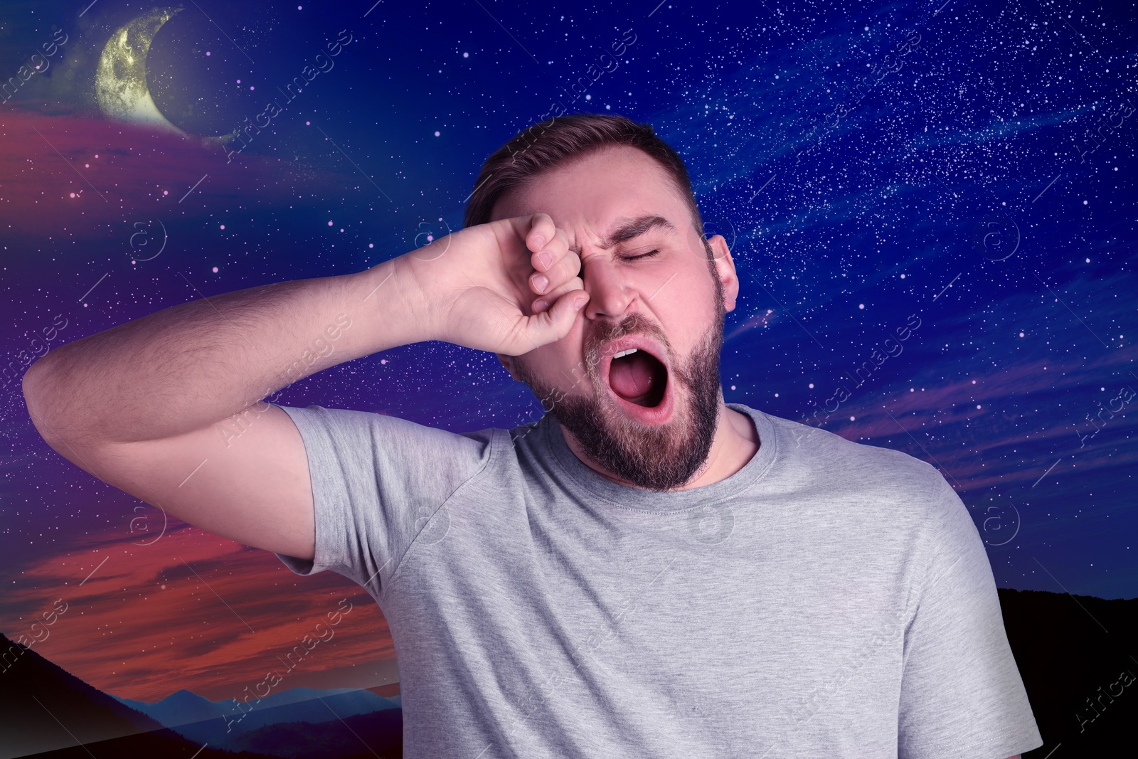 Image of Sleepy young man and beautiful starry sky in night on background