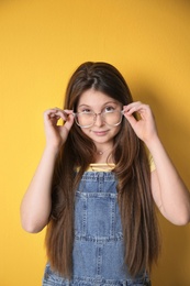 Photo of Attractive teenage girl on color background