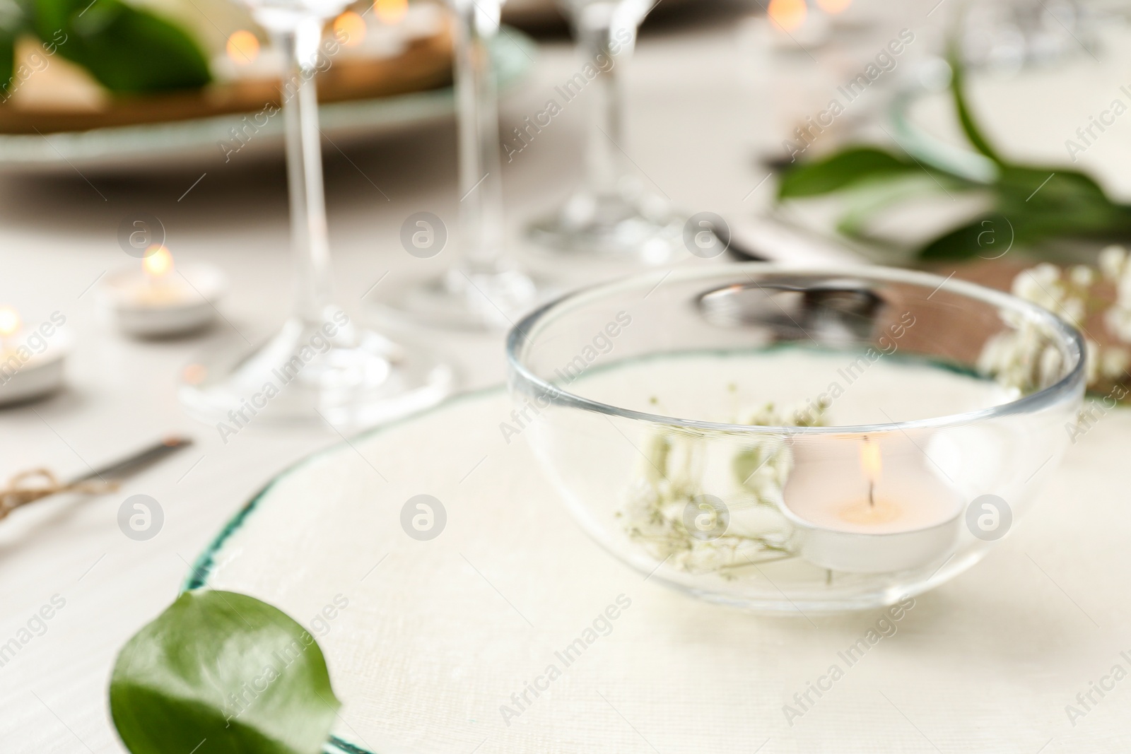 Photo of Elegant table setting with green plants, closeup