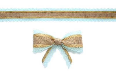 Image of Pretty burlap bow and ribbon with light blue lace on white background 