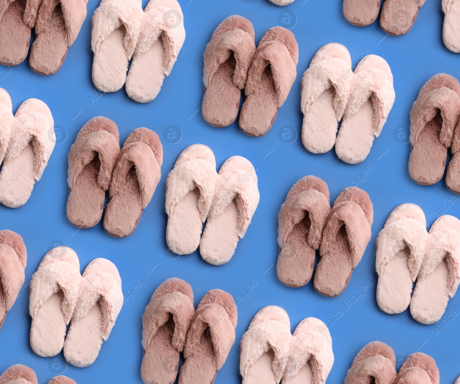 Image of Soft slippers on blue background, top view. Pattern design 