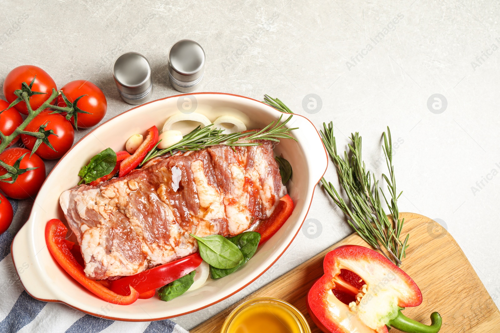 Photo of Raw spare ribs with garnish on light table, flat lay