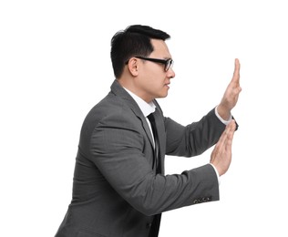 Photo of Scared businessman in suit posing on white background