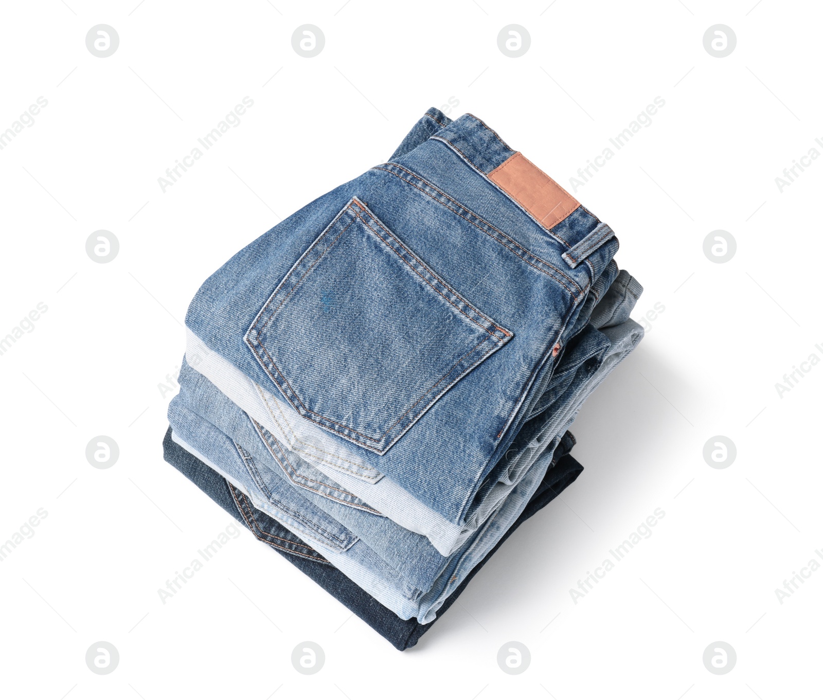 Image of Stack of different folded jeans isolated on white