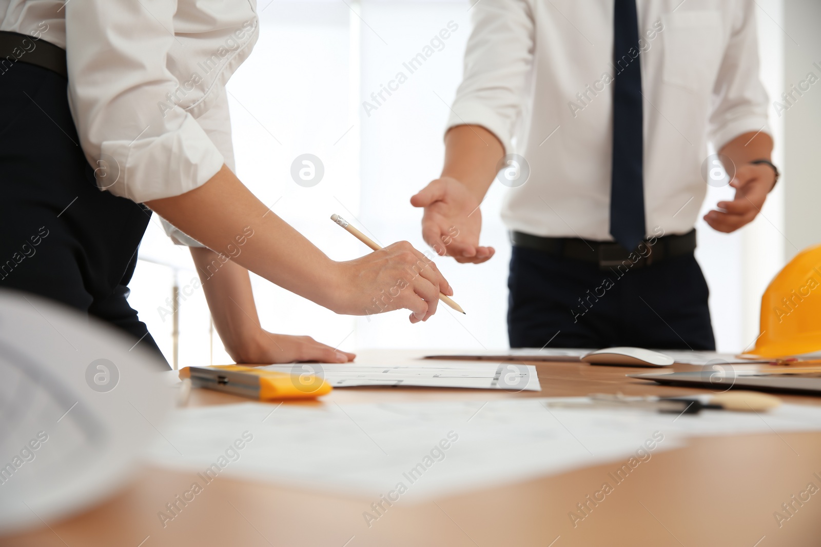 Photo of People working with construction drawings at table, closeup