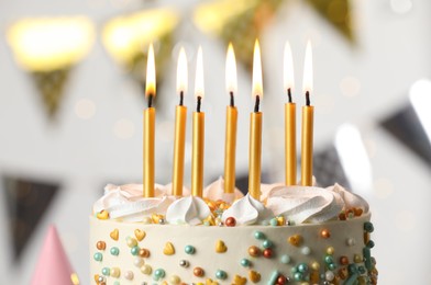 Photo of Beautiful birthday cake with burning candles on blurred background, closeup