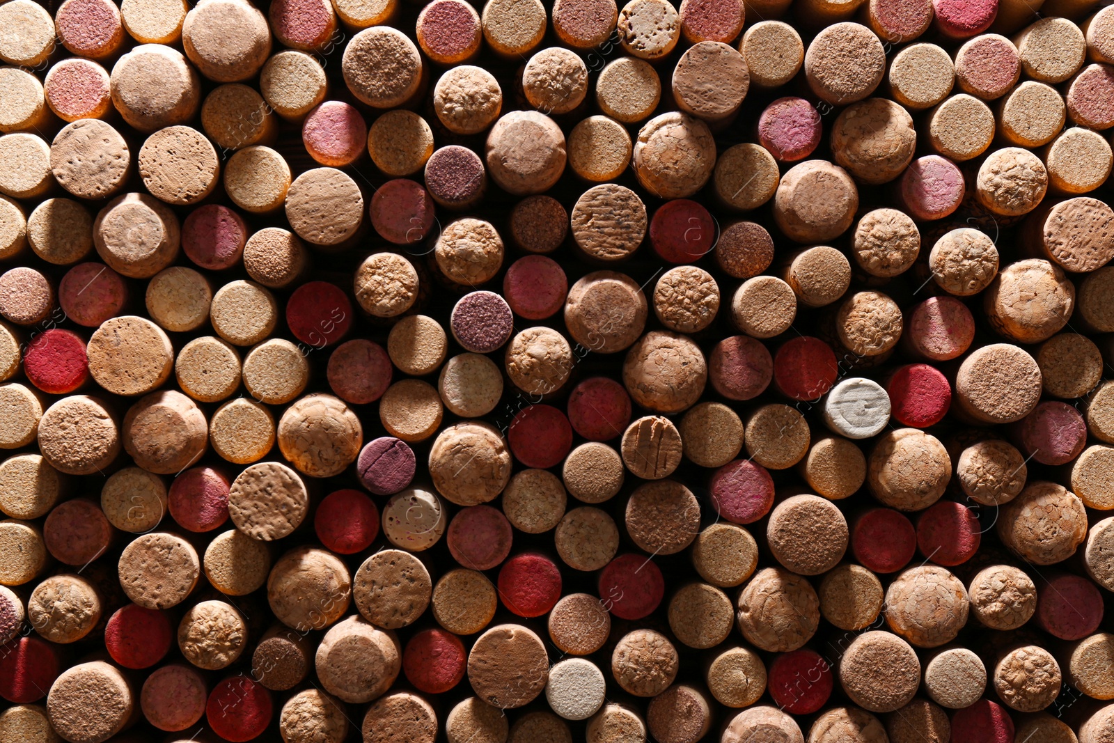 Photo of Many corks of wine bottles as background, top view