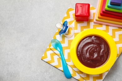 Photo of Flat lay composition with healthy baby food on grey table, space for text