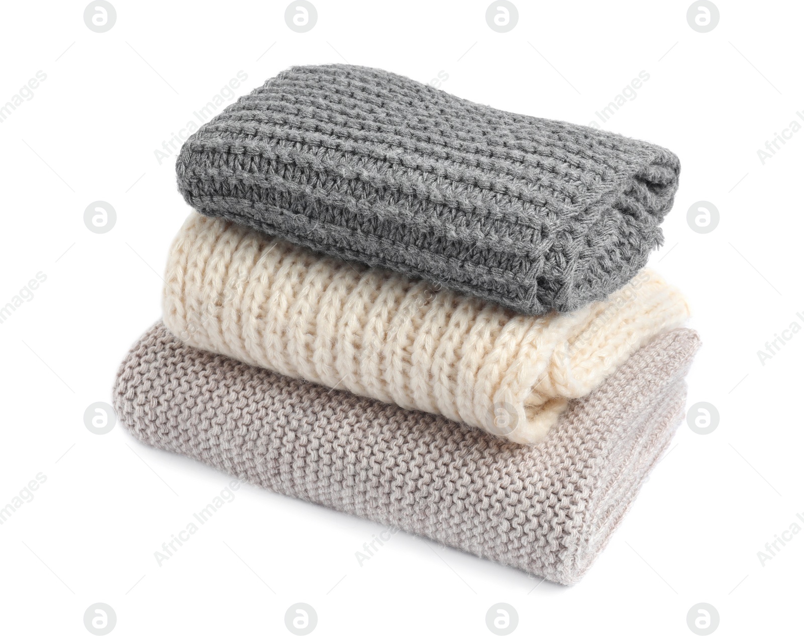 Photo of Stack of knitted scarfs on white background