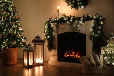 Photo of Beautiful room interior with fireplace and Christmas decor in evening