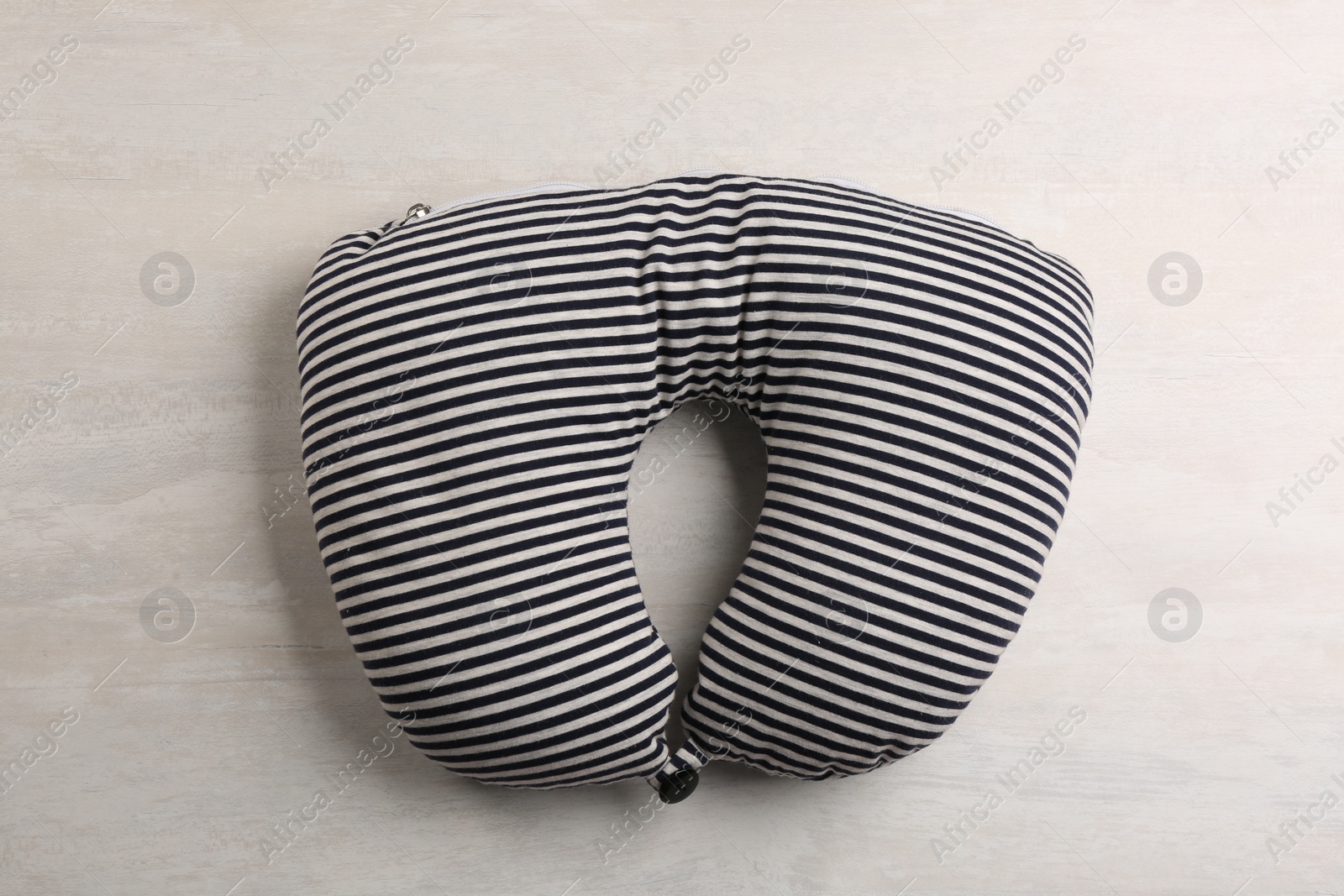 Image of Striped travel pillow on light background, top view