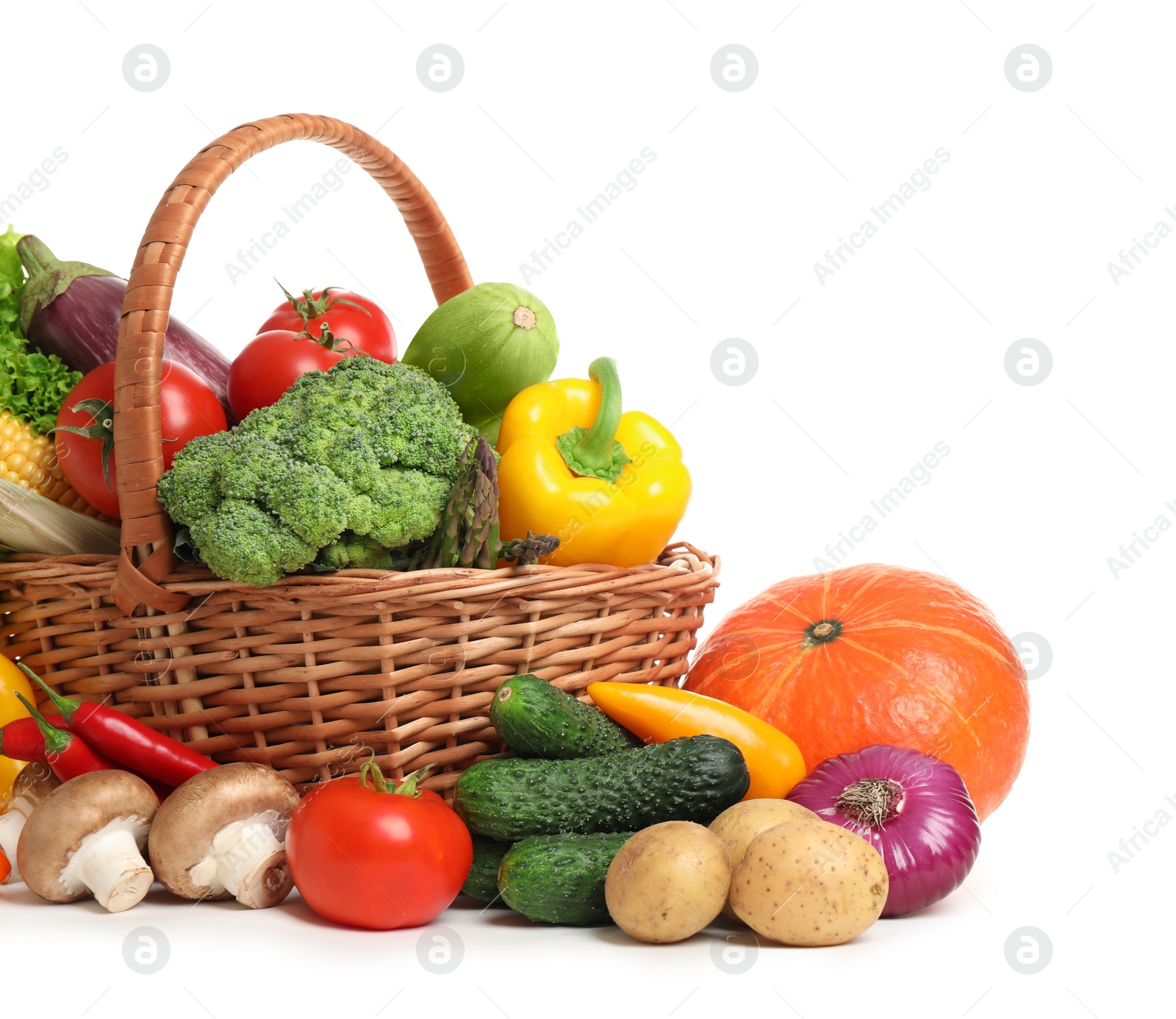 Photo of Wicker basket with fresh vegetables on white background