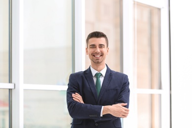 Photo of Young man in office wear on blurred background