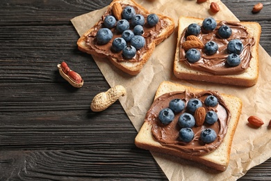 Toast bread with chocolate spread and blueberry on dark background