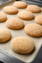 Photo of Delicious sugar cookies on baking sheet, closeup