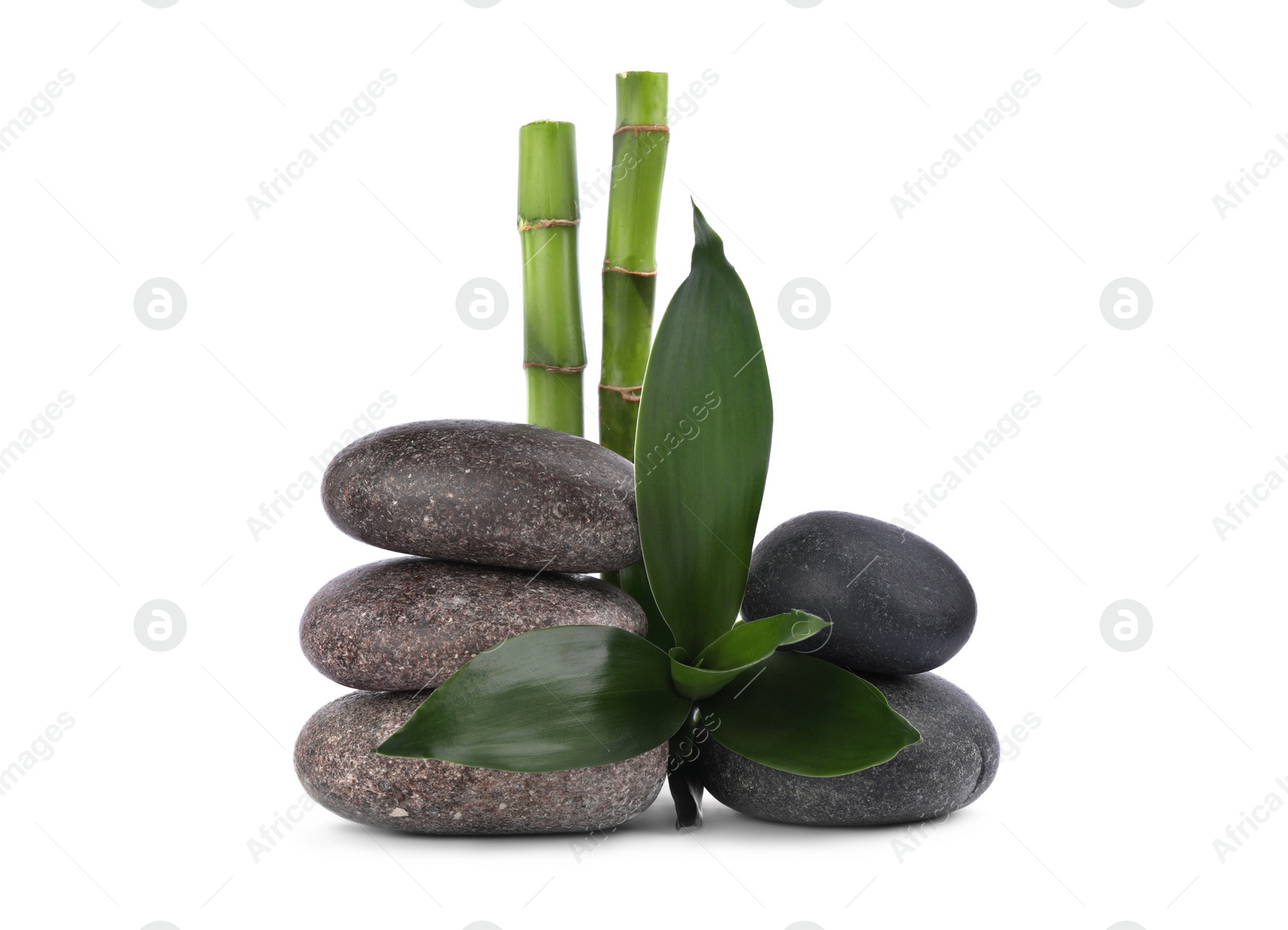 Photo of Stacks of spa stones and bamboo on white background