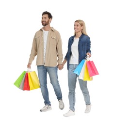 Family shopping. Happy couple with many colorful bags holding hands on white background