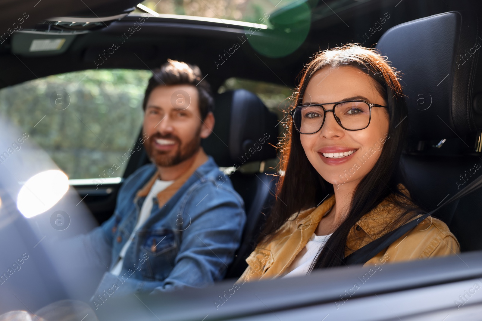 Photo of Happy couple enjoying trip together by car, selective focus