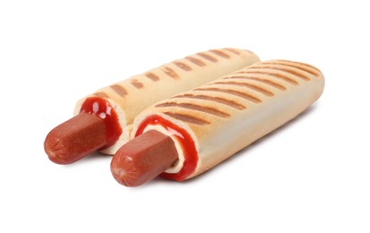 Photo of Tasty french hot dogs with sauce on white background