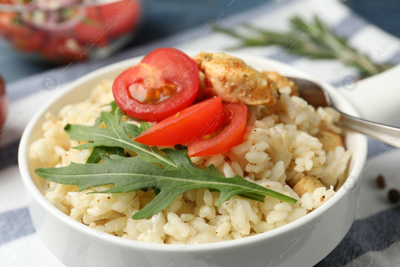 Photo of Delicious chicken risotto served in bowl, closeup