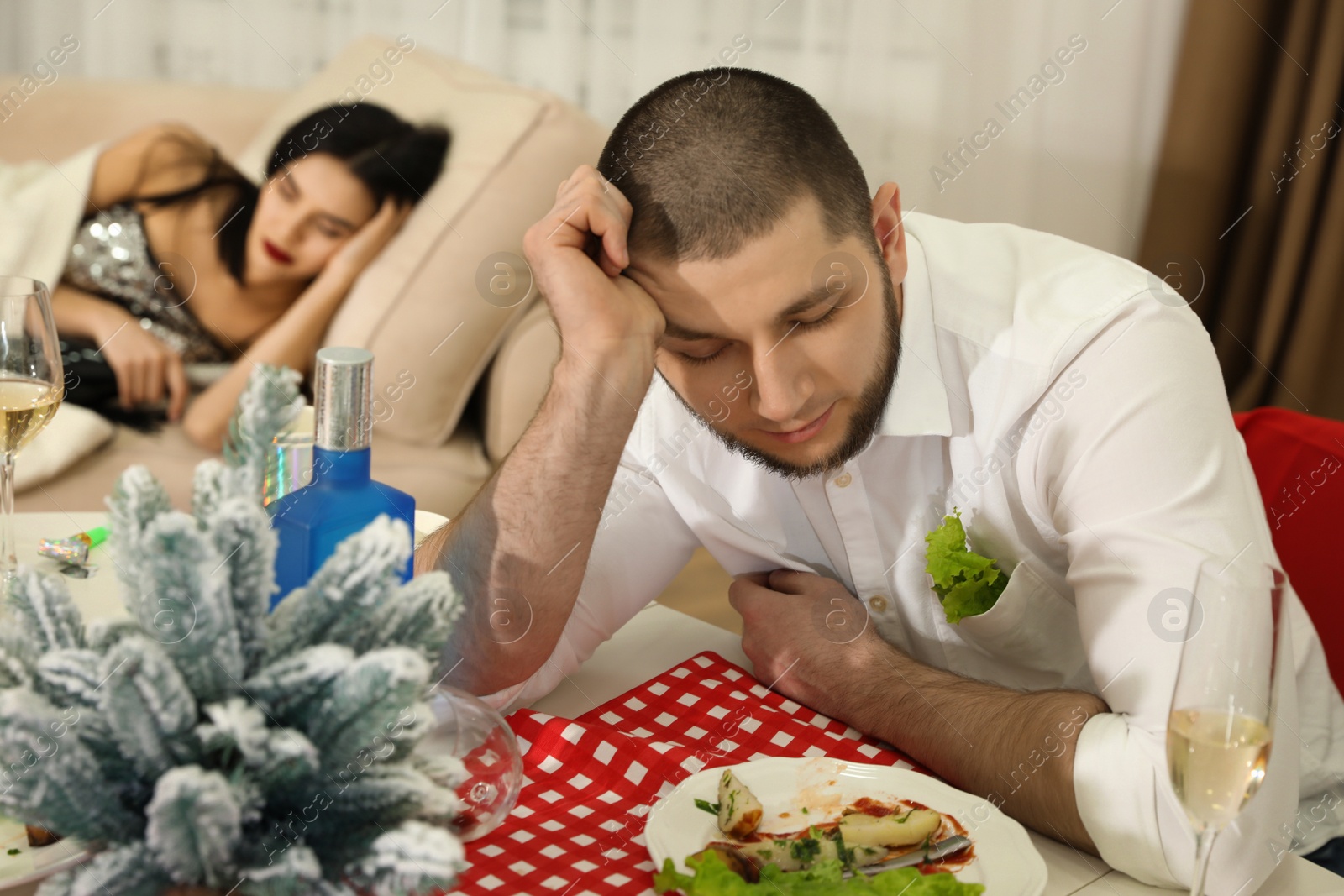 Photo of Man sleeping at table after New Year party