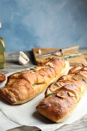 Photo of Delicious homemade garlic bread on table. Space for text