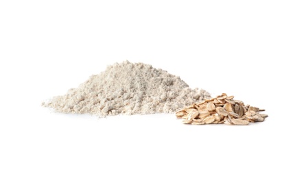 Photo of Piles of oatmeal and flour isolated on white