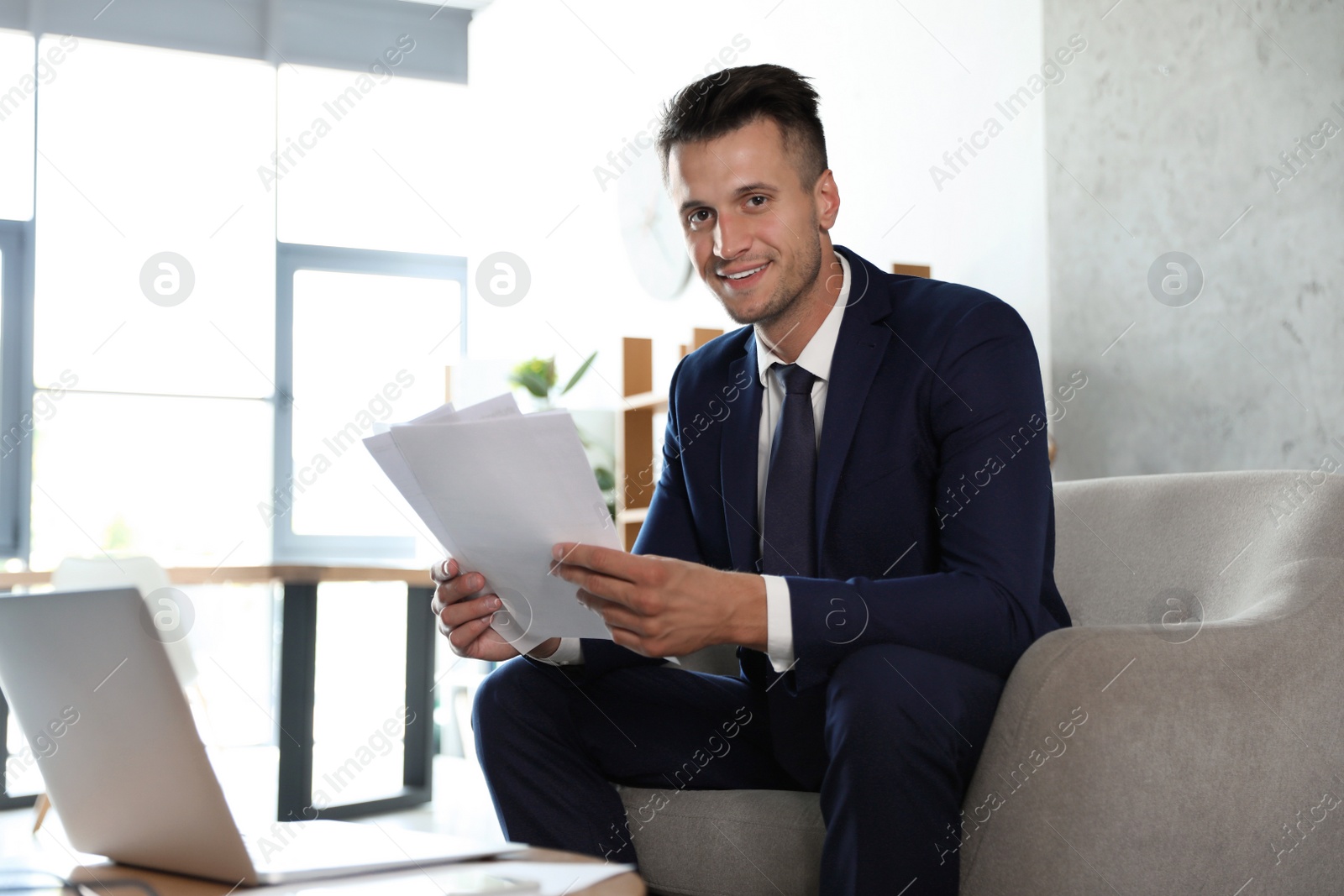 Photo of Male business trainer working with documents in office