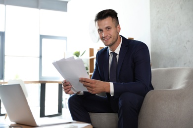 Male business trainer working with documents in office